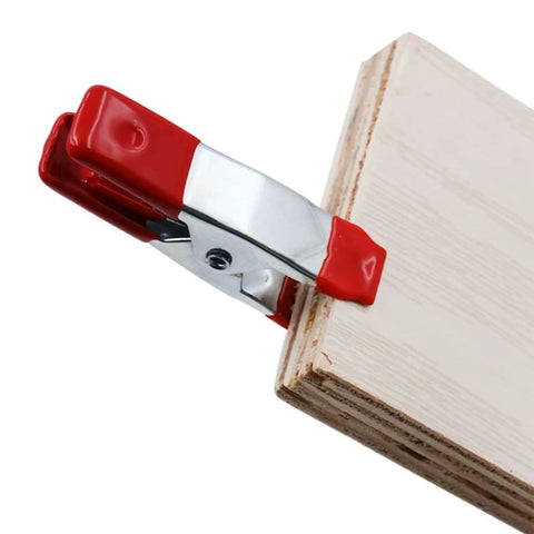 2 Inch Heavy Duty Spring Clamps For Woodworking And Photo Studio Backdrops, Nickel Plated Metal Clips on a wooden board