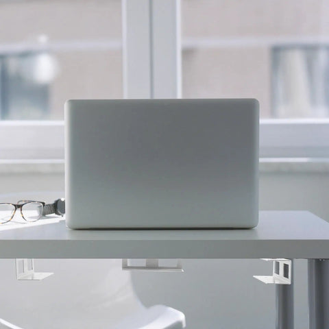 Heavy Hitter Under Desk Laptop Mount Bracket Loaded With Rock Solid Aluminum Construction And Smart Space Saving Layout For Clutter Free Offices And Dependable Ergonomic Computing Setup Silver, secured beneath a desk with a laptop.