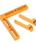 Rock Solid Cnc Workpiece Positioning Fixture Kit For T Slot And Perforated Tables with orange aluminum square and clamps.
