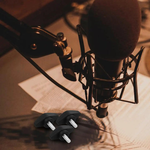 Rock Solid Microphone Stand Thumb Screws Decked Out With Tee Wing Knobs on a studio desk with a microphone.