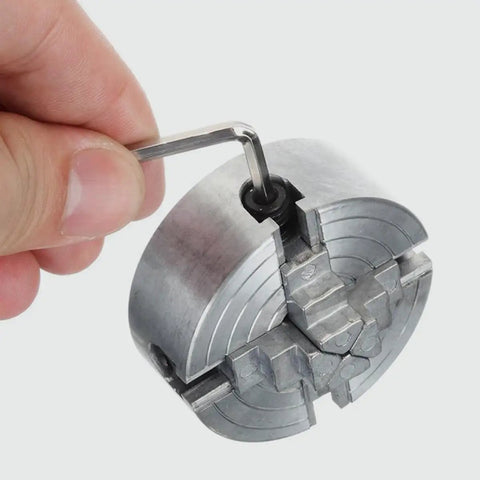 Mini 4-Jaw Lathe Chuck Manual Clamp Hand Chuck For Precision Machining And DIY Metalworking, zinc alloy jaws being adjusted