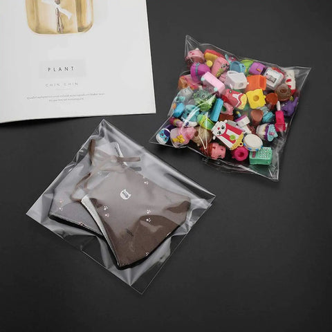 200 Pack Of Freakin Tough Clear Cellophane Cookie Bags Resealable Treat Sacks Heavy Duty Self Sealing Film For Fresh Bakery Goods And Sweet Party Wrapping with assorted toys and cookies.