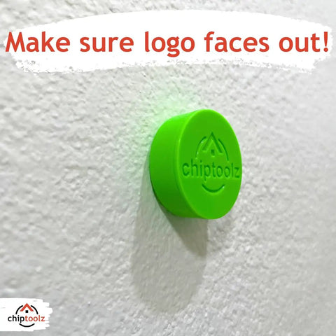 Bright green magnet finder mounted on a white wall, ensuring the logo faces out for optimal use.