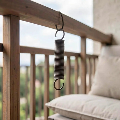 Heavy Duty Two Pack Hook Extension Springs For Recliner Chair Repair Solid Black Steel hanging from a wooden railing outdoors.