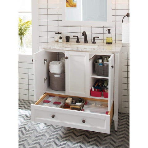 Ladera 8 Inch Widespread Two Handle Bathroom Faucet in Tuscan Bronze on white vanity with open storage below