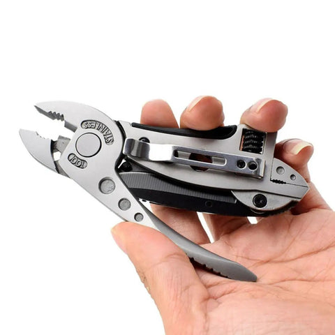 Hand holding Two Piece Portable Stainless Steel Multitool Pliers Set with Wire Cutters and Multi Purpose Wrench for outdoor survival.