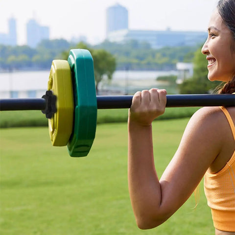 Woman lifting barbell using 8 Pack Dumbbell Bar Collars Clips For Fitness Equipment outdoors, secure quick-twist clamps.