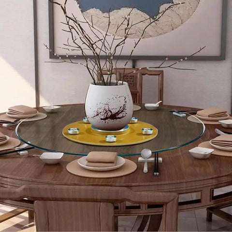 Flawless Finish Tempered Glass Lazy Susan And Smooth Gliding Rotating Serving Tray on a wooden dining table with dishes and decor.