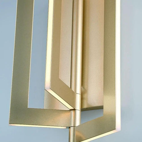 Close-up of Slick Modern Wall Sconce With Asymmetrical Fan Frame LED Light Featuring Water Mill Inspired Gold Finish.
