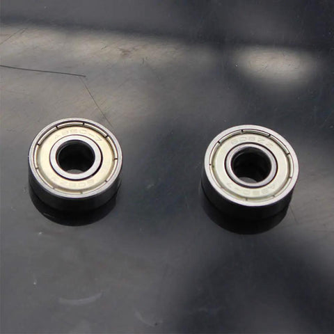 Two Sixteen Pack Abec 7 608Zz Inline Skate Bearings with dual shielded steel construction on a black surface.