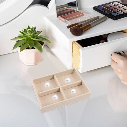 Beige Velvet Jewelry Display Tray With Four Grids And Sturdy Wooden Lid For Ring Bracelet Earring Storage Stackable Vanity Organizer on a vanity.