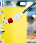 White Adjustable Plastic Tube Flow Control Clamps For Lab And Home Brew Pinch Valves For One Quarter Inch And Five Sixteenth Inch Tubing Regulate Or Stop Water Flow In Five To Eight Millimeter Lines 20 Pack attached to glass tubing.