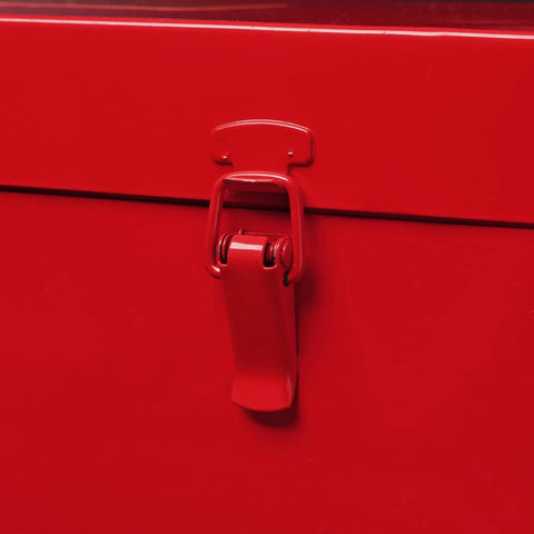 Close-up of the latch on a red heavy duty toolbox, showing the sturdy mechanism for secure storage.