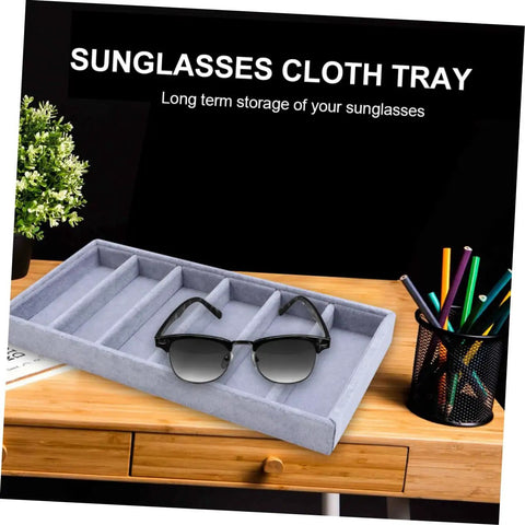 Clean Setup Six Slot Black Sunglasses Display Holder And Jewelry Organizer Box With Solid Build And Scratch Free Tray on wooden desk.