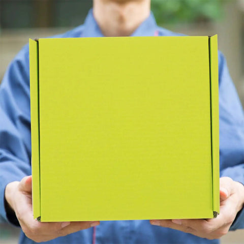 Person holding green corrugated box, part of Green Corrugated Paper Boxes 10 Pack Go To Heavy Duty Packing Boxes For Shipping And Mailing.