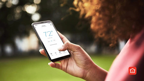 Smart Thermostat T5 Black ENERGY STAR Certified Cut Bills With Easy Temperature Control app on smartphone in hand outdoors