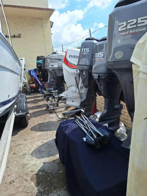 Row of boat outboard motors in a marine workshop setting