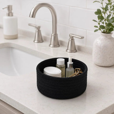 Super Handy Small Woven Cotton Rope Basket For Versatile Home Organization Black Storage Bin holding beauty products on a countertop.