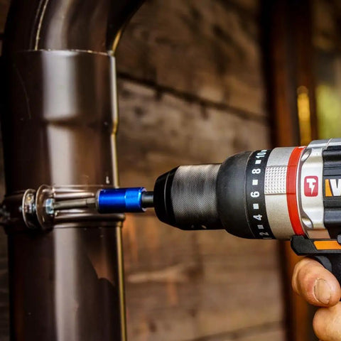 User operates Brushless Cordless Hammer Drill With Two 20 Volt Batteries And Active Hammer Action for fastening on metal pipe.