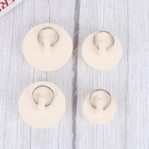 White Rubber Sink Stopper with Hanging Ring 4pcs for Bathtub Drains displayed on a textured background, showcasing different sizes.