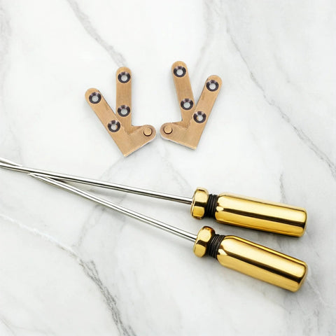 Bronze Hidden Door Pivot Hinges Two Pack Heavy Duty Invisible Lateral Pivot Hardware with gold screwdrivers on marble surface.