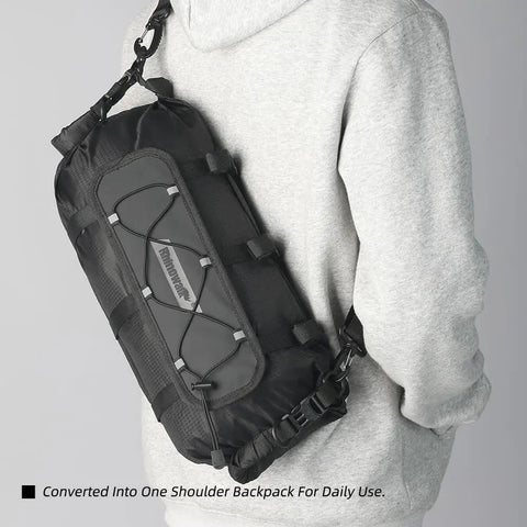 Ride-Ready Waterproof Handlebar Bag 12L Roll-Top Dry Bag worn as shoulder bag, black material, removable harness shown