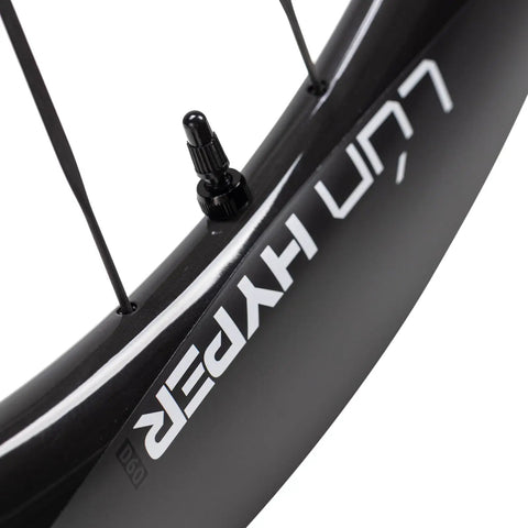 Close-up of Hyper 5 Road Bike Carbon Spoke Wheelset 700C rim, glossy black with white decal, hidden spoke design