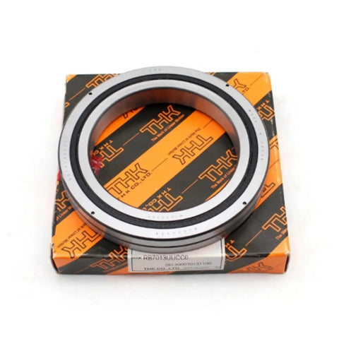 Top Shelf Cross Roller Bearings RB6013 And RB6013UUC0 Precision Slewing Ring on THK packaging for industrial robot arms.