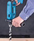 Five Eighth Inch Hammer Drill for Concrete and Wood in use on wooden board, showing durable build and pro grade performance.