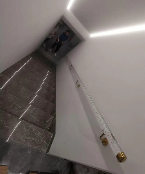 Clear Acrylic Wall Mounted Stair Handrail With Heavy Duty Gold Brackets And Snug Non Slip Grip For Durable Indoor Outdoor Banister Support That Keeps You Steady Zero Sweat Always on a staircase.