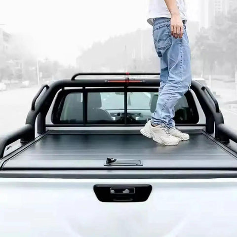 Person standing on Retractable Truck Bed Tonneau Cover For L200 Triton 2024 2025 2026, Aluminum Slats With Weatherproof Seal