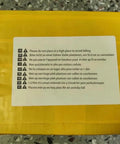 Close-up of a yellow package with warning labels about placement instructions for safety.