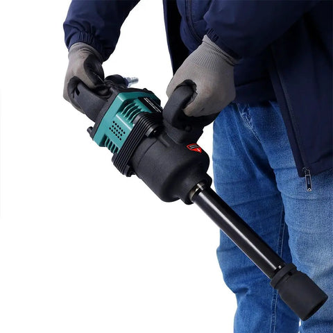 Badass 1 Inch Pneumatic Impact Wrench 1900 Ft Lbs Max Torque 4000 Rpm held by a person in gloves, showcasing tool design for heavy duty use.