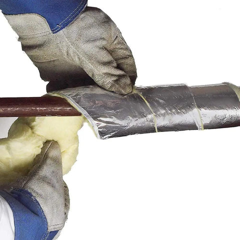 Hands wrapping fiberglass pipe insulation kit for all pipe sizes with 25 ft vapor barrier and 1.6 R value to prevent water pipe freezing.