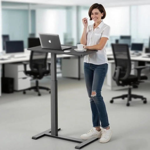 Person using Mobile Standing Desk With Wheels Height Adjustable Pneumatic Laptop Desk in office setting