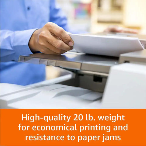Person placing Top Notch Multipurpose Copy Paper 20 Lb 11 X 17 Inches Tabloid Size into printer for jam-resistant printing.