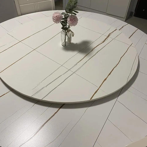 Built Tough 23 Inch Marble Lazy Susan With Butter Smooth 360 Degree Swivel Action And Rock Solid Nonslip Base on a dining table with flowers.