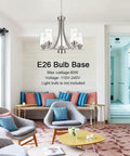 Traditional 5 Light Chandelier In Brushed Nickel With Clear Glass Shades Dope Modern Hanging Pendant Lighting over lounge area.
