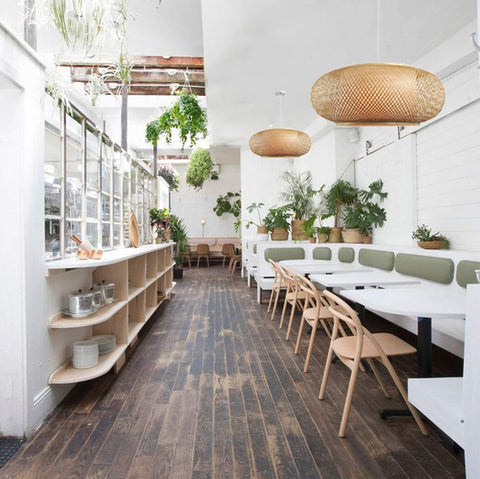 Vintage Bamboo Woven Pendant Chandelier With Birdcage Shade And Wicker Light Fixture in a rustic dining area.