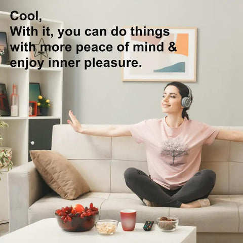 Person relaxing on sofa with headphones in a cozy living room, surrounded by snacks and decor, feeling peaceful.