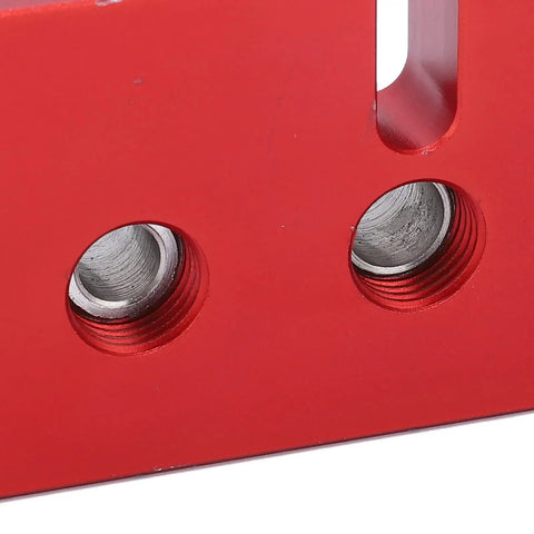 Close-up of Top Shelf Wood Doweling Jig Drill Kit With Spot On Scaling Ruler And Rugged Aluminum Frame showing precision bushings in red.