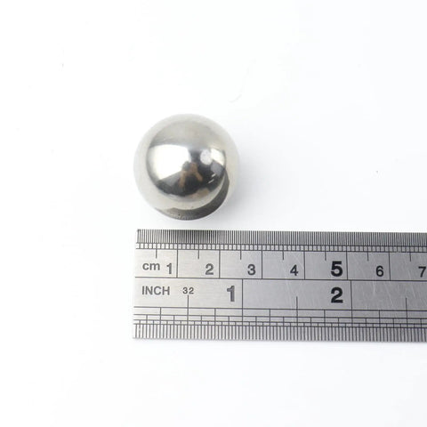 Top Shelf 304 Stainless Steel Precision Bearing Balls 25 mm showing a mirror polish finish with ruler for size reference.