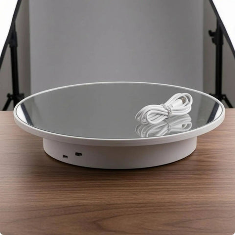 Stupendous Electric Rotating Display Stand With 360 Degree Turntable Rotation For Professional Jewelry Photography and Small Item Filming featuring a mirrored round base and power cable.
