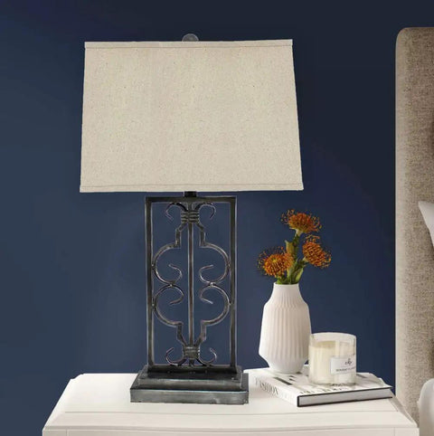 Metal Table Lamp With A Stacked Rectangular Base, Dope Scrollwork, And A Rectangular Shade For Modern Home Decor on nightstand
