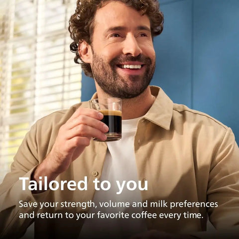 Man enjoying a coffee in a glass, smiling, showcasing a tailored coffee experience with the Fully Automatic Espresso Machine.