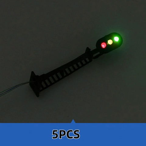 Badass 5 Piece Ho Scale 3 Light Block Signal Set Hella Durable Brass Prewired LED Railroad Lights With Red Yellow Green Bulbs 6.5cm Height For Model Trains 12V To 18V Powered Sick Upgrade For Any Layout Setup Totally Ready To Rock - close-up of LED signal light with illuminated green, yellow, and red bulbs.
