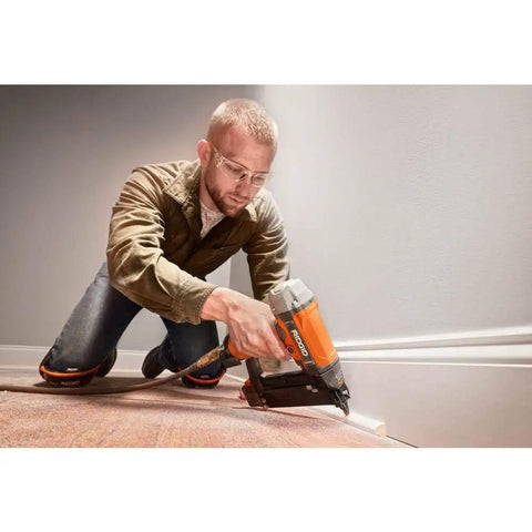 Man using Pneumatic 18 Gauge Brad Nailer Two And One Eighth Inch with Clean Drive Technology plus tool bag for trim work.