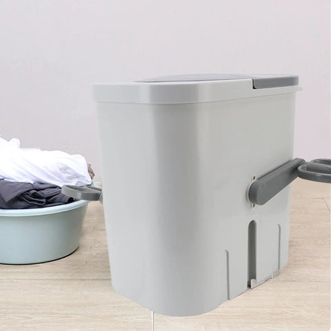 No Fuss Portable Clothes Washer Game Changing Hand Crank Operation, compact gray laundry machine beside a laundry basket.