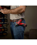 Person holding 12 Volt Cordless Hex Screwdriver Kit with Two 1.5Ah Batteries, Charger, and Tool Bag in a workshop setting.