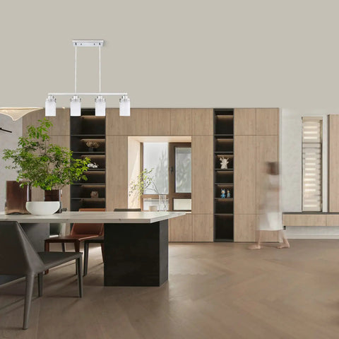 4 Light Kitchen Island Pendant Chandelier in brushed nickel with frosted glass shades hanging above a modern dining table